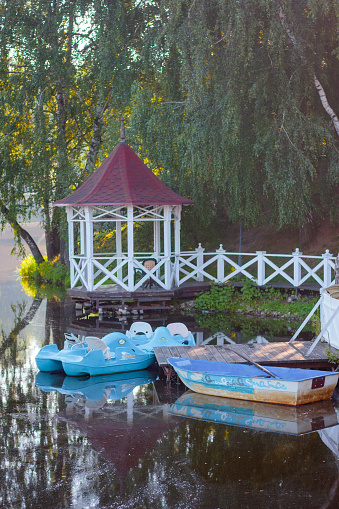 Blue boats at the wooden piere at lake water