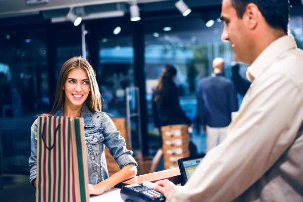 istock Female customer paying for clothes in boutique 868664476