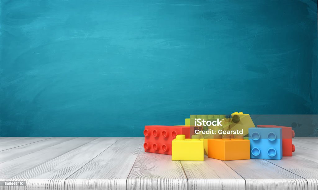 Render 3D de un bloques de juguete, mintiendo en un montón colorido sobre un escritorio de madera sobre un fondo azul - Foto de stock de Niño libre de derechos