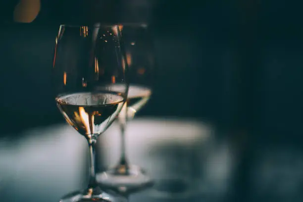 Photo of Two glasses of white wine on a table