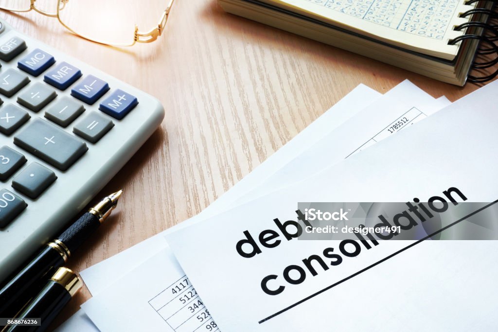 Documents with title debt consolidation on an office table. Debt Consolidation Stock Photo