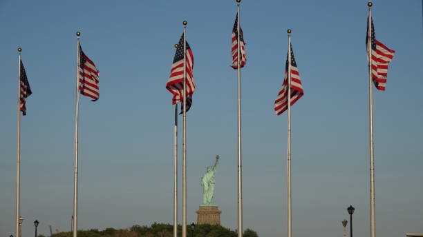 istock American Flags And Statue Of Liberty 868677356