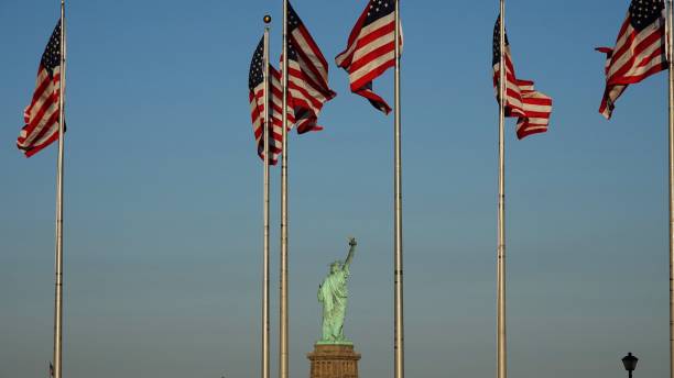istock Statue Of Liberty And Us Flags 868677378