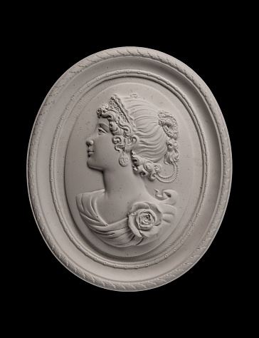 plaster face in a medallion on a black background
