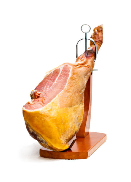 istock Whole  jamon on a wooden stand isolated on white background 868678362