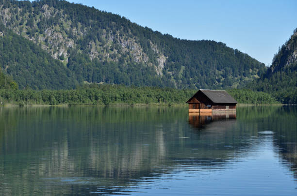 istock Mountain lake with swimming house 868678932