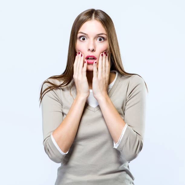 istock Beautiful woman surprised over white background. 868679286
