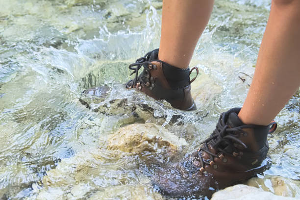 istock Crossing River in Hiking Shoes 868679354