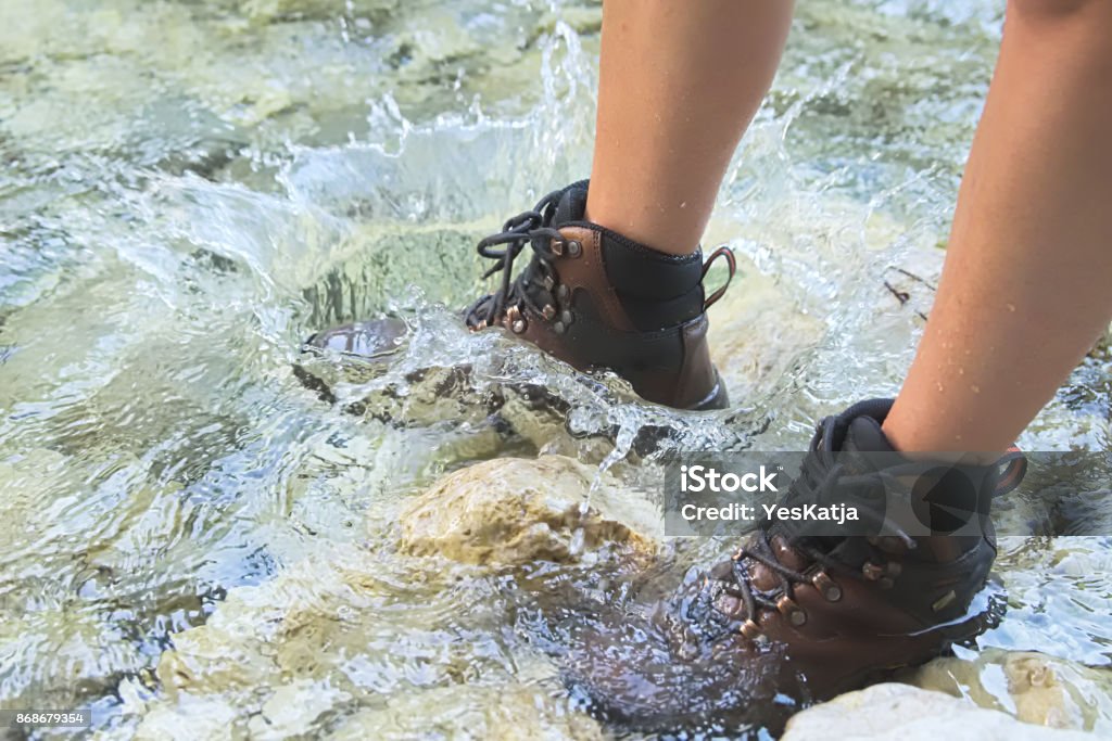 Crossing River in Hiking Shoes Crossing Small River in Hiking Shoes Hiking Boot Stock Photo