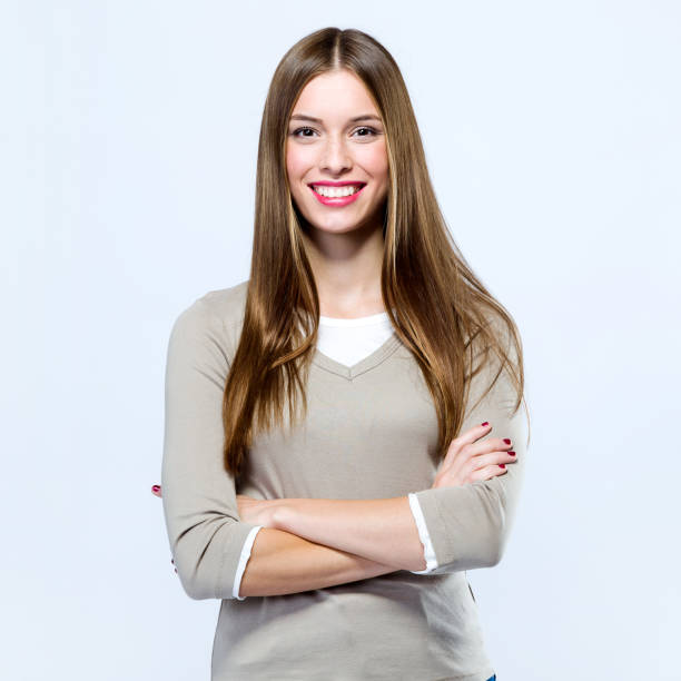 istock Beautiful young woman looking at camera over white background. 868679514