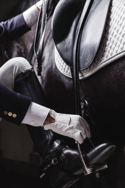 Jockey saddle up horse for the equesterian ride