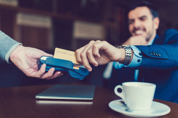 istock Businessman at cafe paying with credit card 868691740
