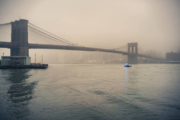 istock Brooklyn bridge at foggy evening 868695702