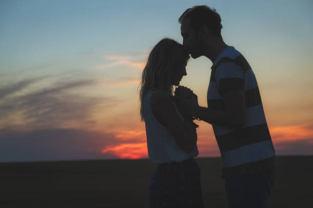 istock Young couple enjoying outdoors in the field. 868696052