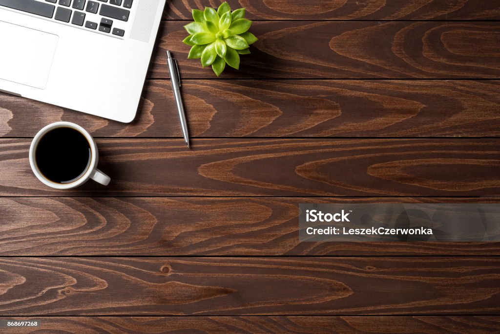 Laptop with office accessories on wooden table. Business background Desk Stock Photo