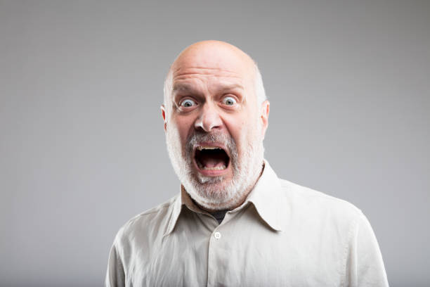 strong exaggerated fear expression of an old man fear on the face of an old scared man - concept of elemental FEAR making a face stock pictures, royalty-free photos & images