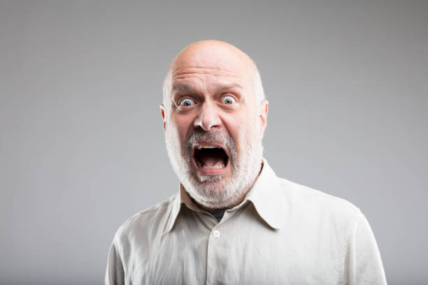 strong exaggerated fear expression of an old man fear on the face of an old scared man - concept of elemental FEAR ugly face stock pictures, royalty-free photos & images