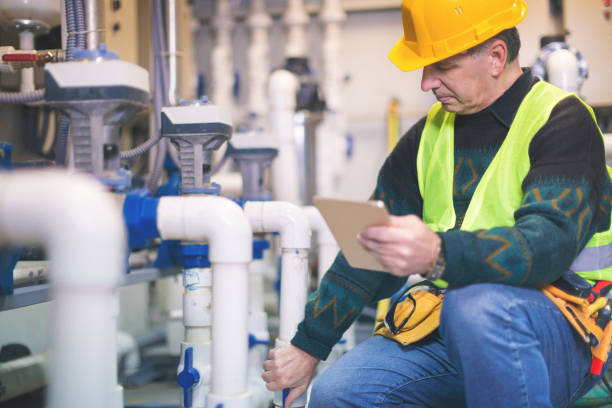 istock Senior repairman in boiler room checking pipes 868703342