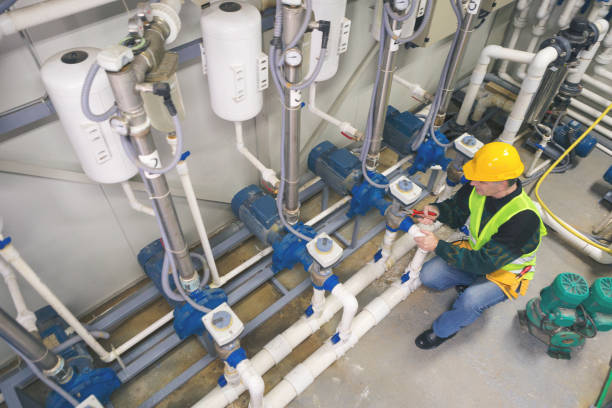 Senior man in a boiler room working. Shallow DOF. Developed from RAW; retouched with special care and attention; Small amount of grain added for best final impression. 16 bit Adobe RGB color profile.