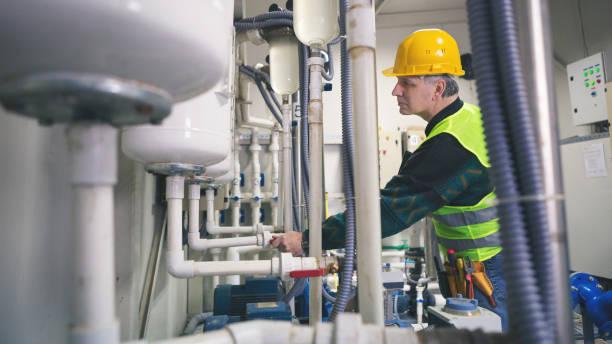 istock Senior repairman in boiler room checking pipes 868704484