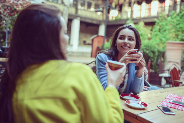 istock Two friends enjoying coffee together in a coffee shop 868711016