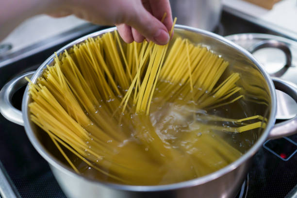 istock Spaghetti is cooked in a large saucepan with boiling water. 868716590