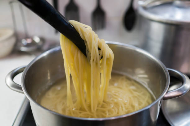 istock Spaghetti is cooked in a large saucepan with boiling water. 868716644