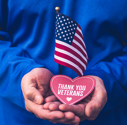 Veterans Day in America. Male hands holding thank you message