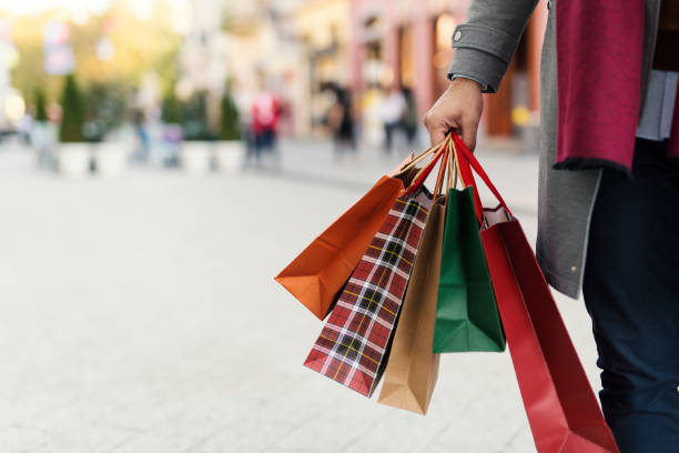 Man at the shopping Man holding shopping bags with presents on the street coat garment photos stock pictures, royalty-free photos & images