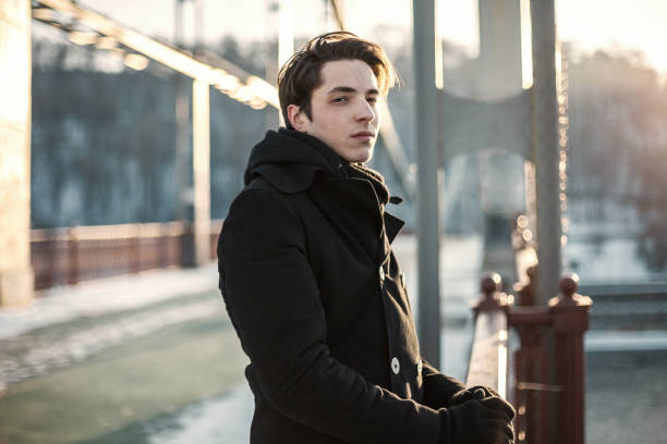 istock Portrait of a thoughtful guy standing on the bridge 868724858