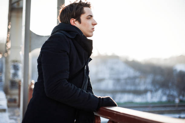 istock Thoughtful guy standing on the bridge looking into the distance 868724872