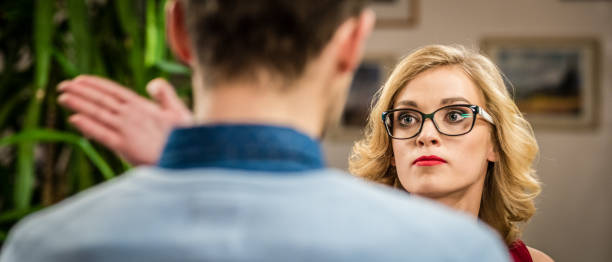 istock Blonde haired woman slapping a man 868730804