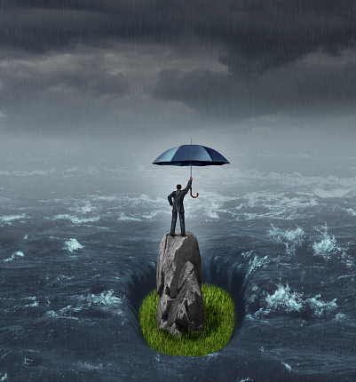Businessman success thinking concept as a person holding an umbrella in the middle of a flood or ocean standing on a dry rock with grass floor with 3D render elements.
