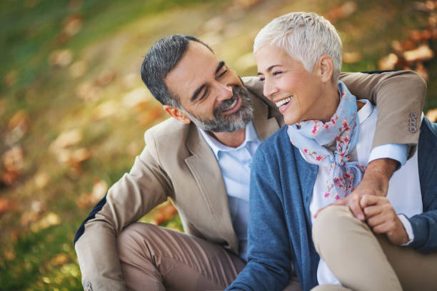 istock Mid aged couple in a park 868734122
