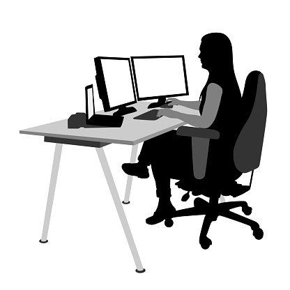 Woman working at the office with a double computer monitor setting