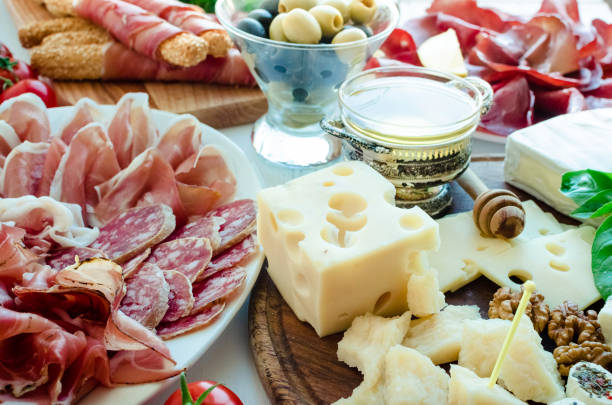 Table full of mediterranean appetizers Table full of mediterranean appetizers, tapas or antipasto. Assorted Italian food set. Delicious snack on party or picnic time. Chopping board with meat and cheese. Italian style banquet. salumeria stock pictures, royalty-free photos & images