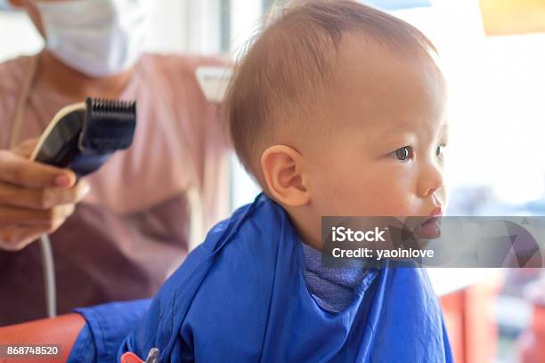 Cute Little Asian 18 Months 1 Year Old Toddler Baby Boy Child Getting A  Haircut At The Hairdressers Barber Shop For The First Time Stock Photo -  Download Image Now - iStock