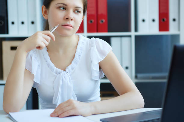 istock Beautiful young student or intern working  on a laptop in the office. 868752062