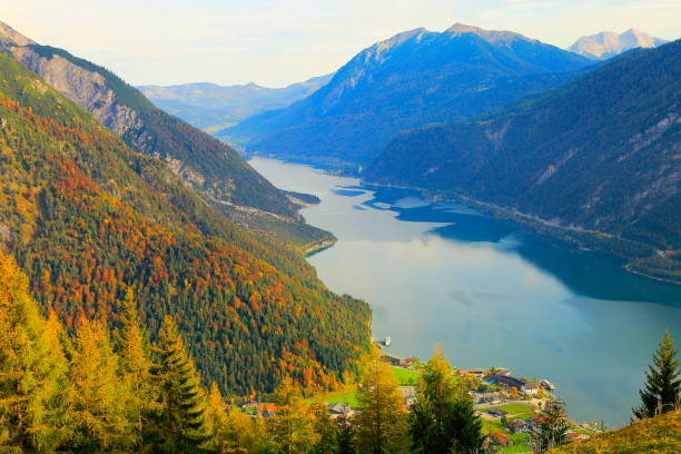 istock Above idyllic Achensee turquoise lake reflection, alpine landscape in Austrian Tirol - Karwendel mountain range border with Bavarian alps in Germany - Majestic alpine landscape in gold colored autumn, dramatic Tyrol Snowcapped mountains panorama, Austria 868752614