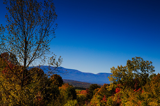 Catskill Mountains on a fall day near Hudson NY off 23. Fall colors of trees, blue sky, autumn.
