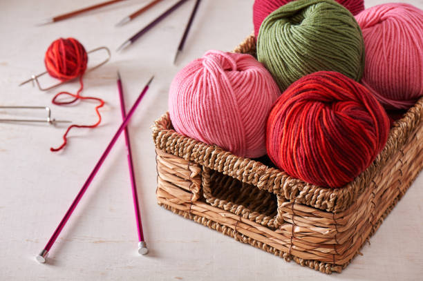 Skeins of yarn in basket and knitting needles Skeins of yarn in basket and knitting needles knitting needle photos stock pictures, royalty-free photos & images