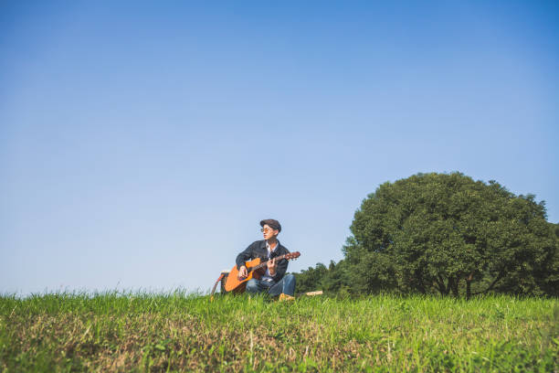 istock young man playing musical instrument on lawn 868770202