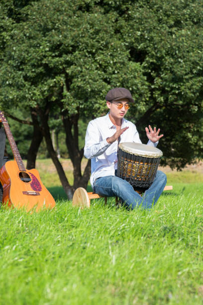 istock young man beating a djembe drum at a sunny day 868772708