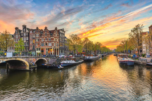 Amsterdam sunset city skyline at canal waterfront, Amsterdam, Netherlands stock photo