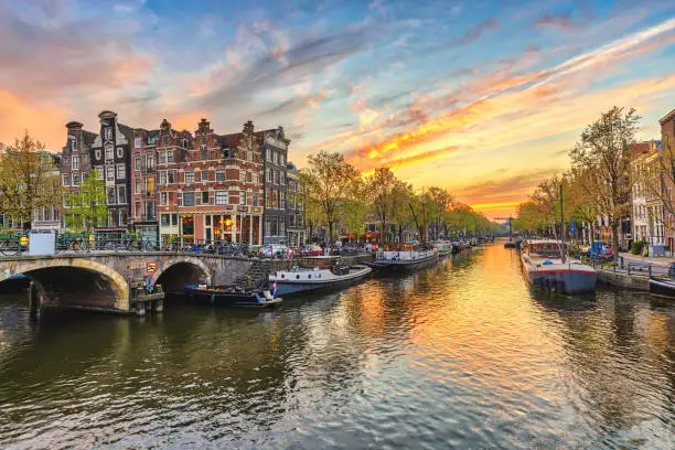 Photo of Amsterdam sunset city skyline at canal waterfront, Amsterdam, Netherlands