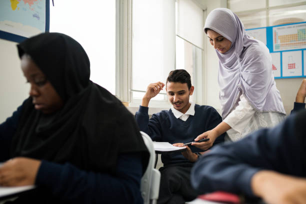 diverse muslim children studying in classroom