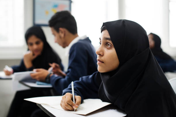 diverse muslim children studying in classroom diverse muslim children studying in classroom arabic girl stock pictures, royalty-free photos & images