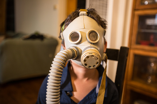 Child wearing nuclear gas mask during nuclear fallout