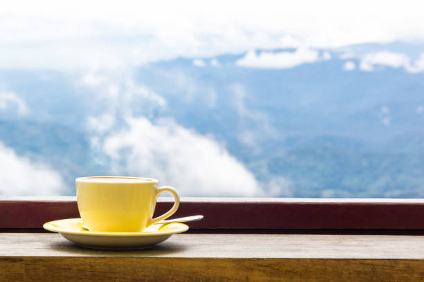 istock Coffee Mug On Wooden Top Table In Arial View Of Mountian. 868795816