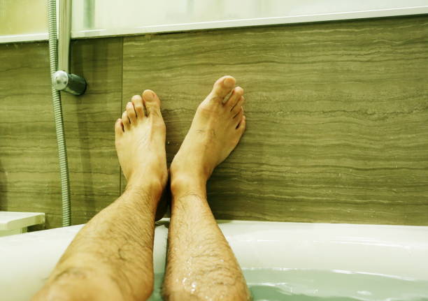 istock Foot of a man in bathtub 868796490